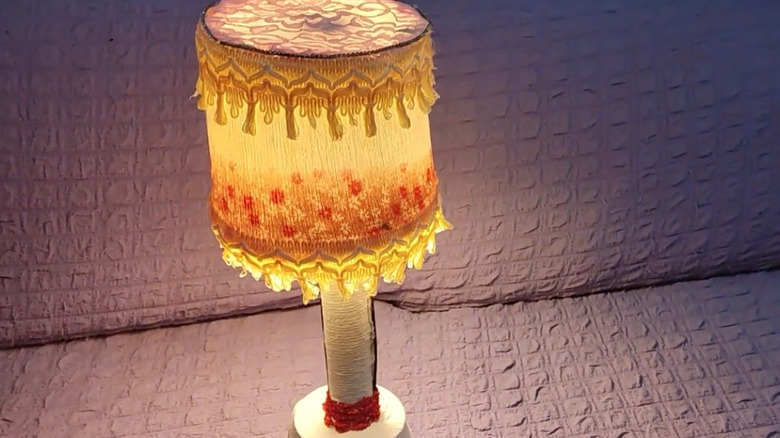 Lamp with a shade made out of a decorated yogurt tub