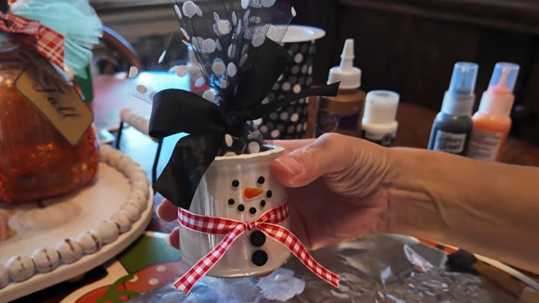 A glass yogurt jar decorated like a snowman