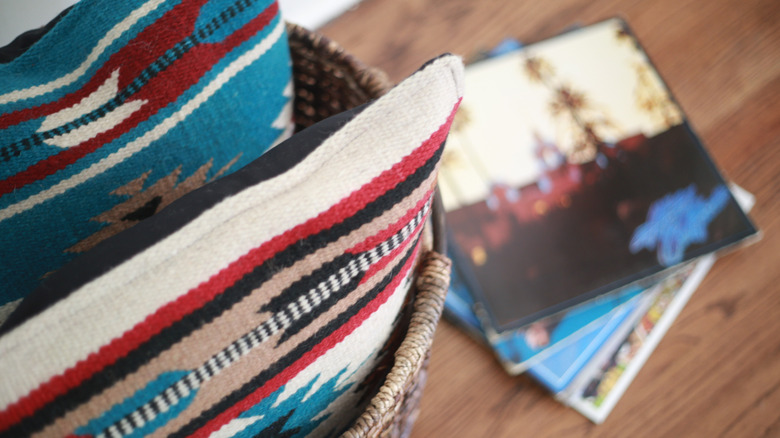 Southwest-themed pillows and a stack of vinyl records