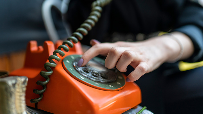 Dialing an orange rotary phone