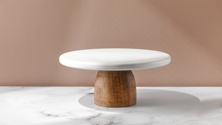Cake stand with a wood base on a marble counter