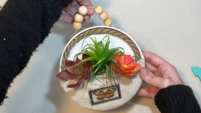 Old coffee lid turned into hanging planter decor