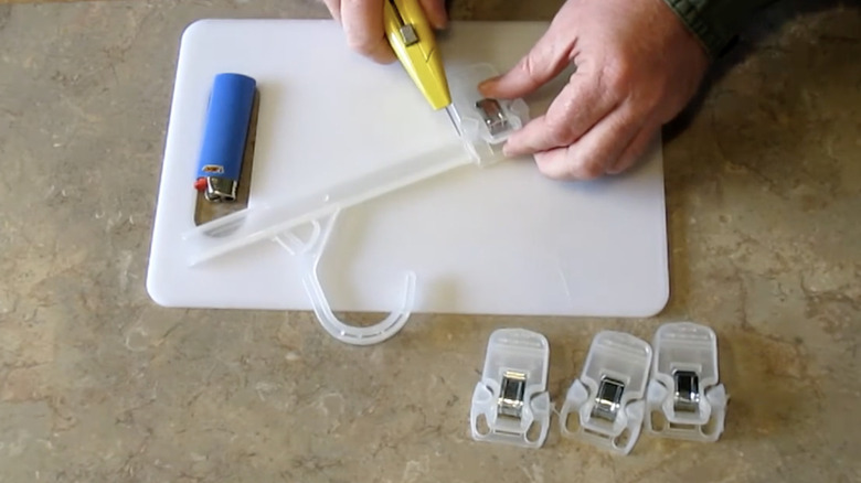 Cutting off the clips on a pants hanger to repurpose as a chip clip