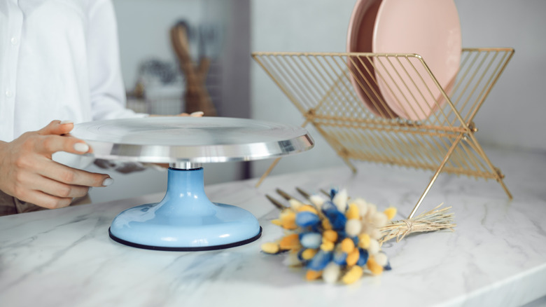 Cake stand with a wood base on a marble counter