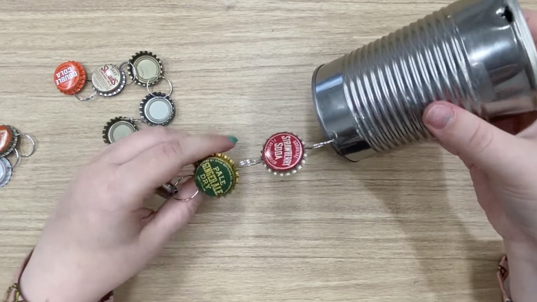hands crafting DIY bottle cap wind chimes