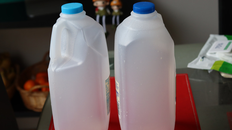 two empty milk jugs