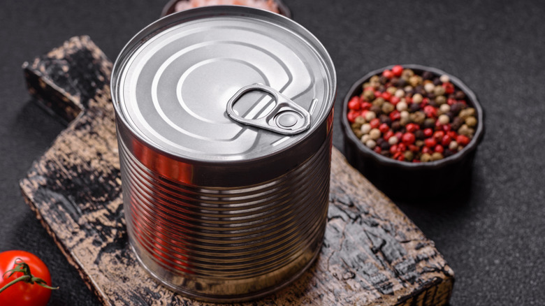 a large, plain tin can on a cutting board