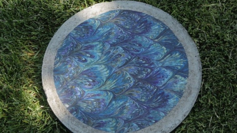 A DIY stepping stone made from paver and fabric