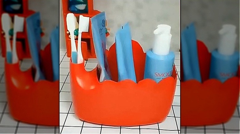 Laundry detergent bottle turned into a bathroom caddy for organization