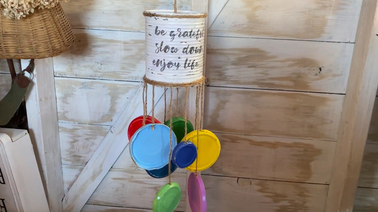 Rainbow-colored wind chime made from jar lids