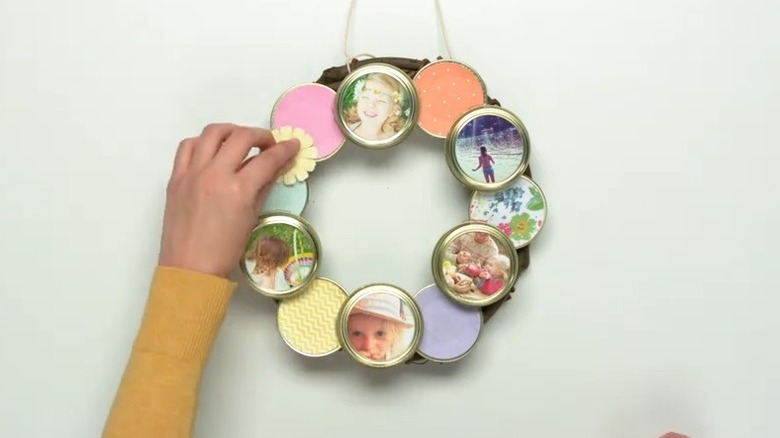 Woman making photo wreath out of canning jar lids