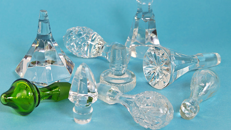 Glass bottle stoppers on blue surface