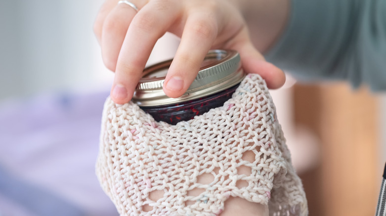 Taking the lid off of a mason jar with a knit doily
