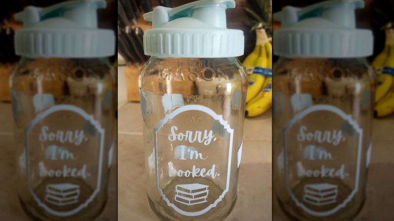 A glass jar drinkware with a pour spout