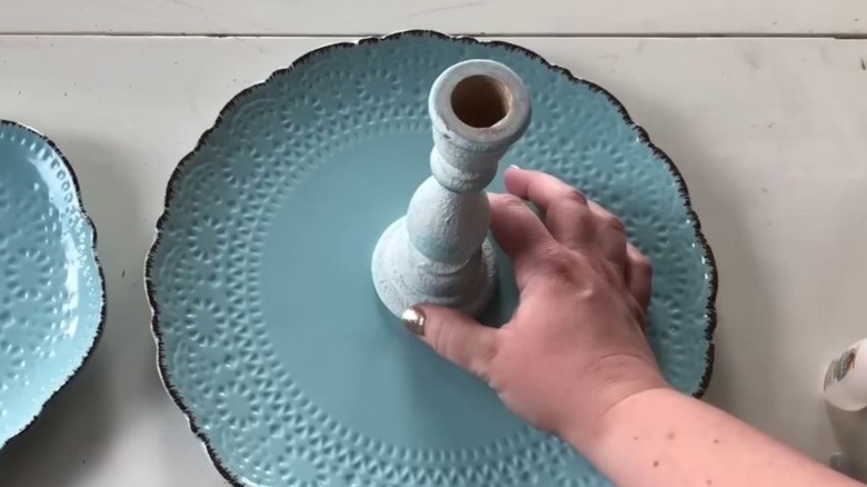 Old teal plate with a painted teal candle stand in the middle