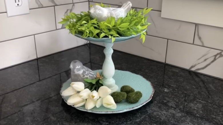 Old dishes turned into two-tiered tray DIY with decorative items placed in it