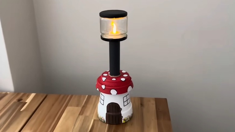 Old nursery pot turned into DIY mushroom lantern