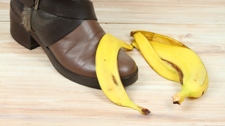 Banana peel laying over a brown leather boot's toe