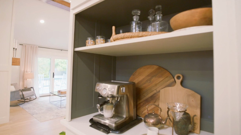 Kitchen coffee bar on a large cabinet's open shelf