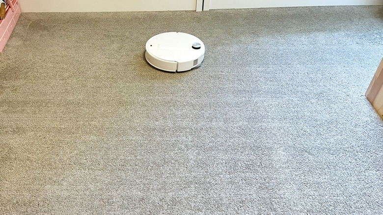 Roborock Qrevo Edge 3 Pro robot vacuum cleaning in a linear pattern visible on carpet
