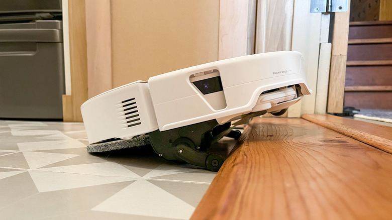 Roborock Qrevo Edge 3 Pro robot vacuum navigating a up a tall flooring transition