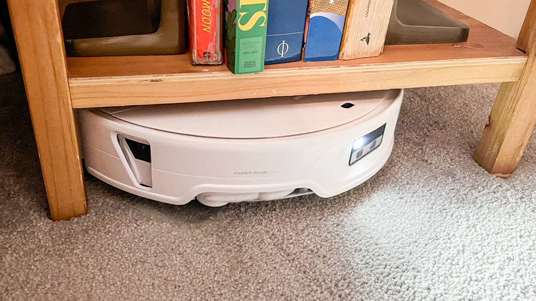 Roborock Qrevo Edge 3 Pro robot vacuum navigating under a low nightstand