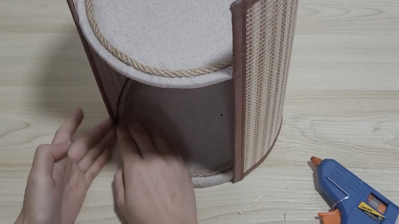 A DIYer makes a bathroom organizer out of plastic lids