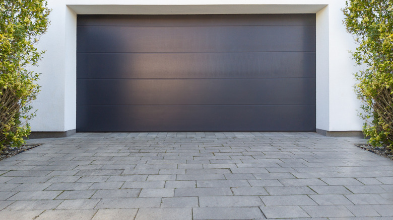 Modern garage door with pavered driveway