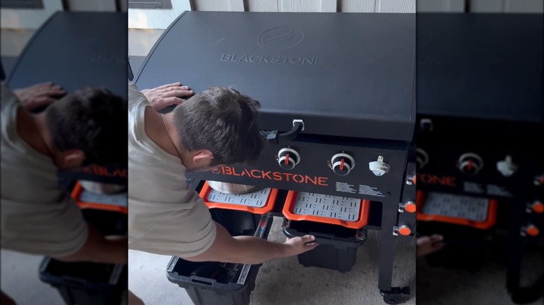 Man opening DIY Blackstone storage drawers