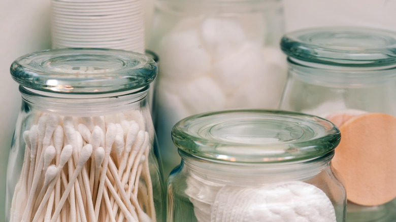 Clear jars with cotton swabs and cotton balls