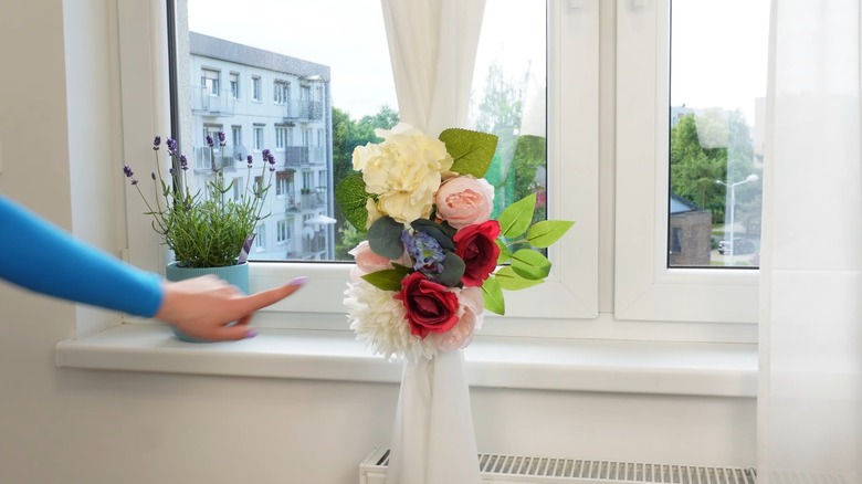 Flowers as a tieback in the middle of a white curtain