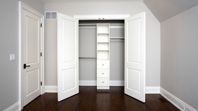 large closet doors take up space in an empty room