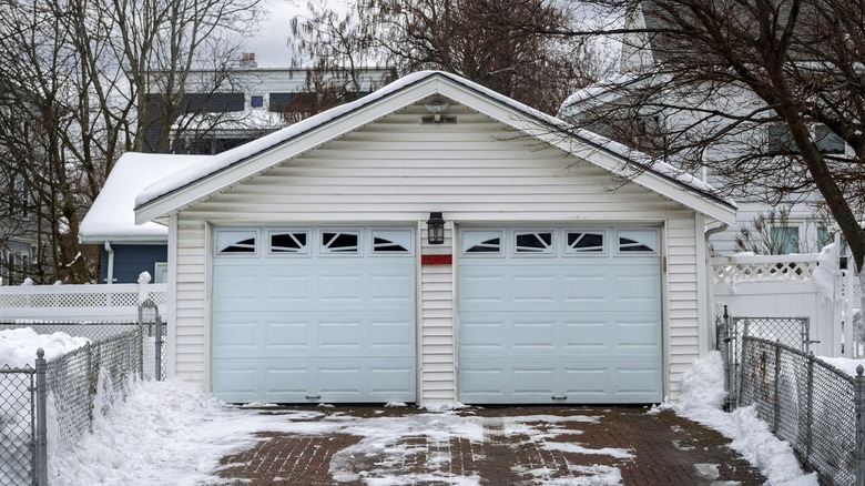 White garage covered by snow and looking cold