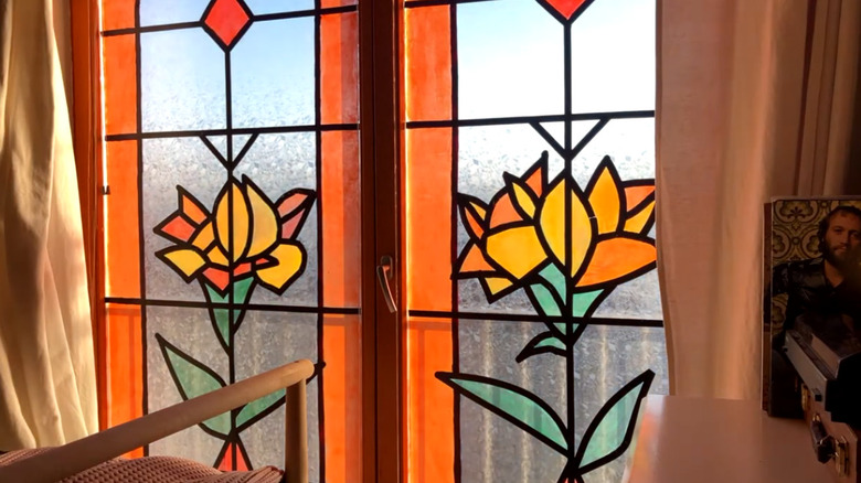 Faux stained glass windows depicting orange flowers
