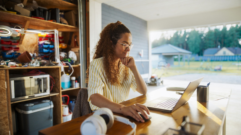 A person shopping online in the garage
