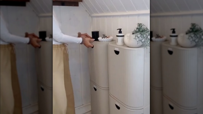 IKEA GÅRDSBUTIK bins mounted on the wall for sorting laundry in a small bathroom