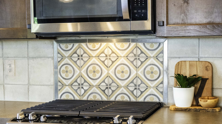 A range with patterned tile backsplash