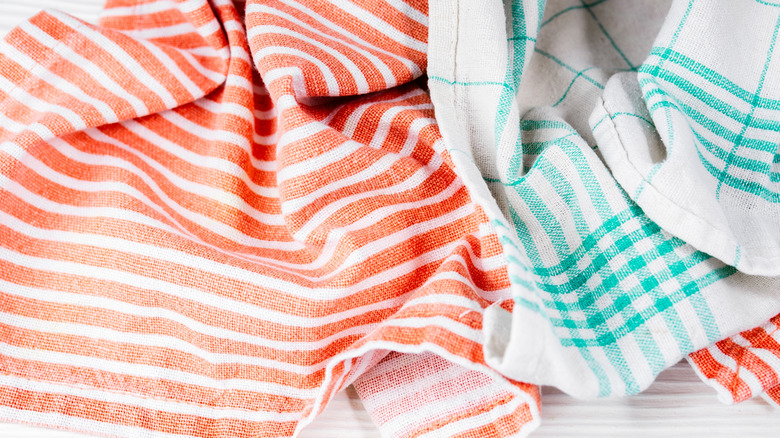 Cluttered kitchen towels on table