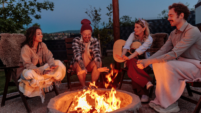 People sitting around a fire at night