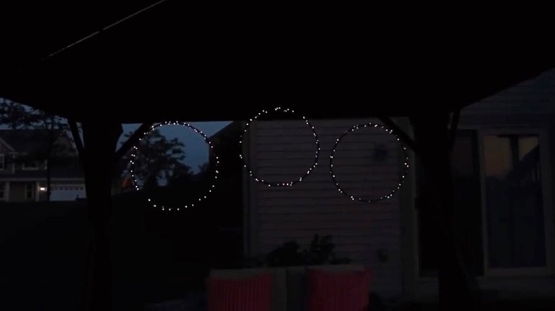 Hoops hanging in a gazebo with string lights wrapped around them