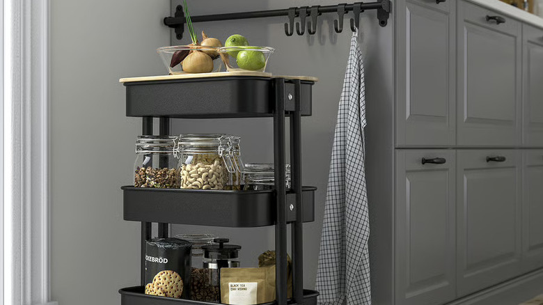 metal IKEA RÅSKOG utility cart in kitchen with pantry and food storage