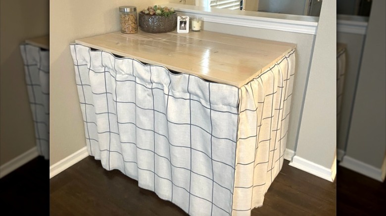 Dog crate with a DIY fabric cover and wood top