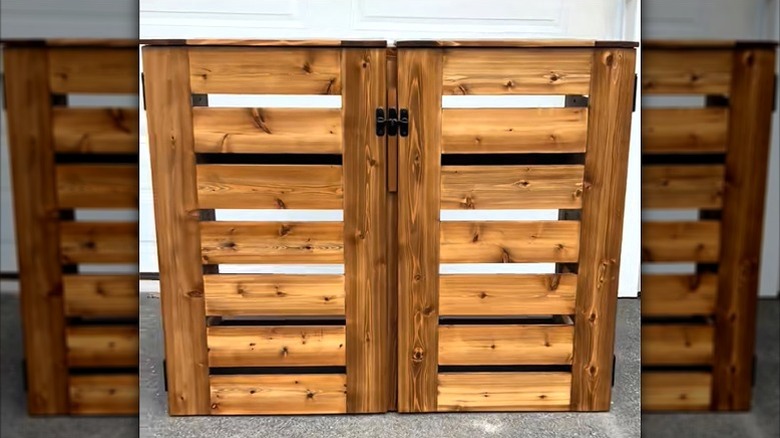 Wooden garbage cart enclosure stained brown