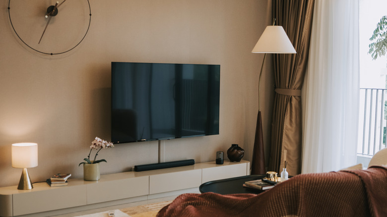 Wall-mounted TV in minimalist living room with cord cover