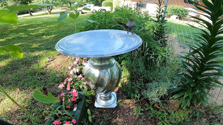 Birdbath made with a lamp as the pedestal