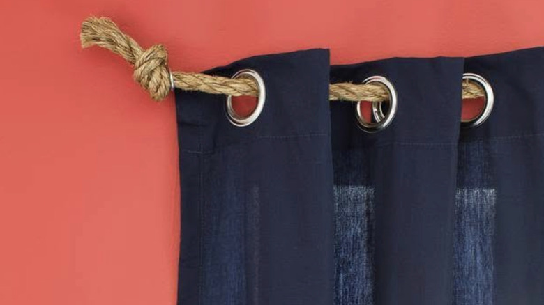 Navy blue curtains hung up with a jute rope