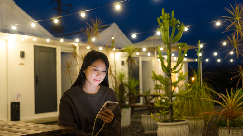 Person sitting on a patio at night
