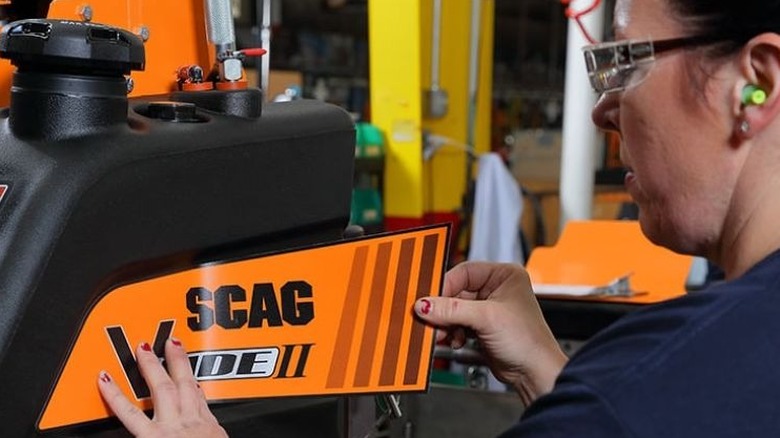 woman assembling scag equipment