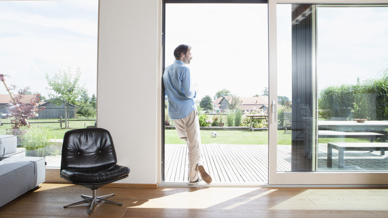Sliding glass doors open with house beyond