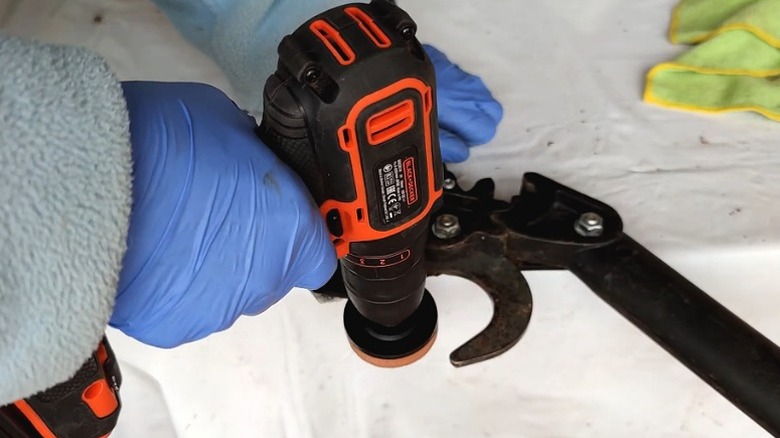 Sharpening pruning shears with drill and sharpening stone attachment